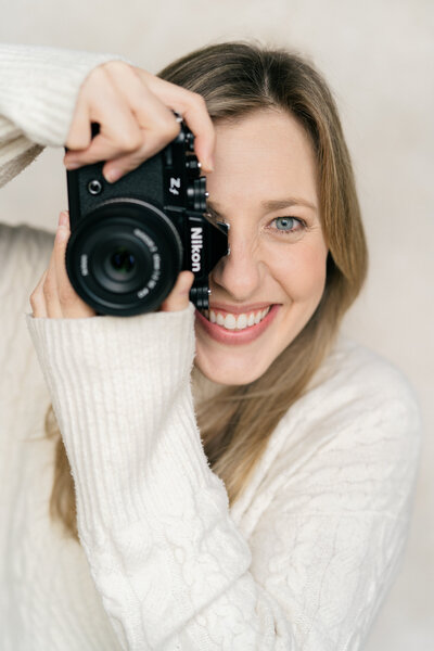 Maine Photographers | Carrie Pellerin smiling while using her nikon zf