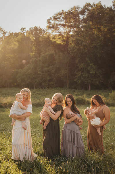 Golden hour group photo of mothers holding their children