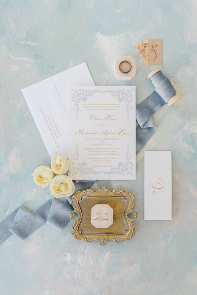 wedding invitation and details on a blue background