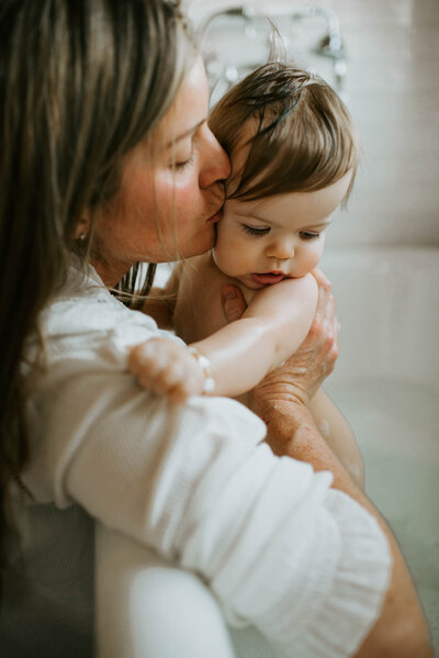 Family Photographer, Mother kissing the cheek of her child