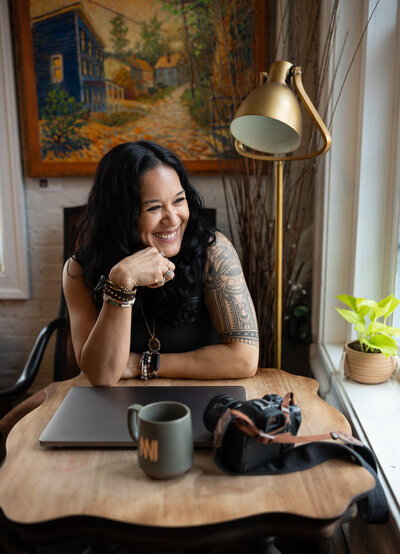 A-Website-Designer-laughs-during-her-Brand-photoshoot-in-Ellicott-City-near-Baltimore-Maryland-with-Ingrid-Berrios-photography-at-Backwater-Bookstore.