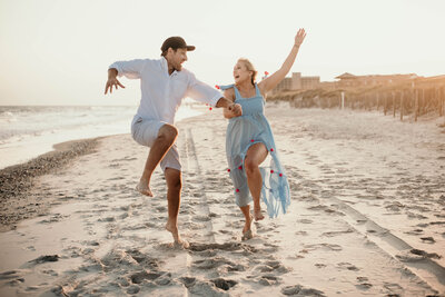Couple dances down the beach