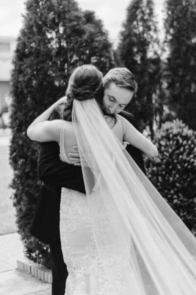 bride and groom embracing in black and white vintage style photo