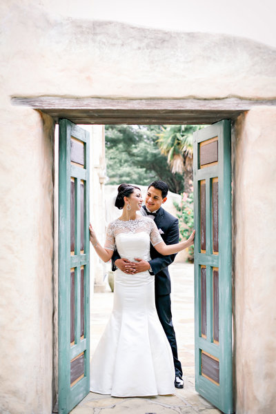 husband and wife embracing by door