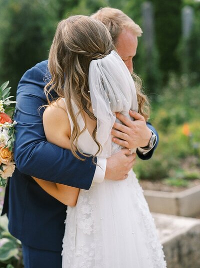 Bride and Groom hugging at Reiman Gardens