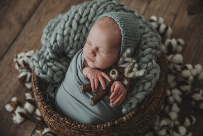 Newborn boy in knitted outfit