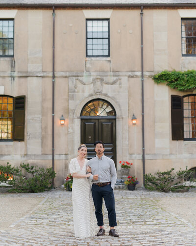 owners of seamless photography, kaylyn leighton and joe sinthavong stand together for their engagement photos at a french countryside estate
