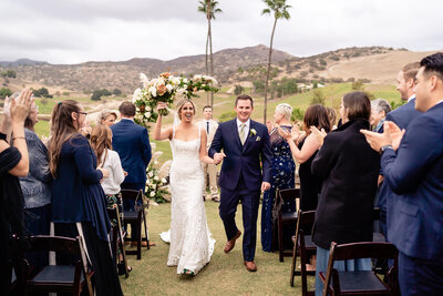 Bride and groom walking down aisle at their wedding at San Diego Safari Park