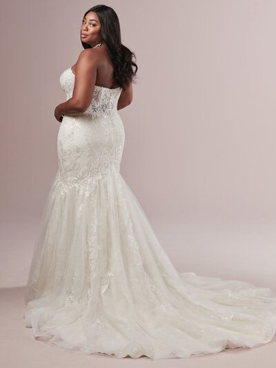 Crystal beadwork and delicate appliques cover this strapless fit and flare gown.