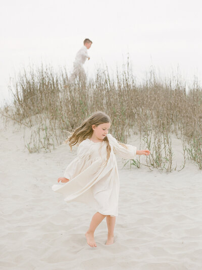 children playing in the dunes in charleston on isle of palm