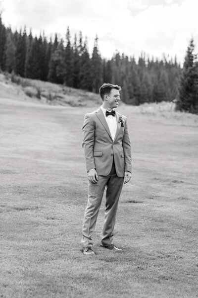 groom in bow tie smiling and looking dapper