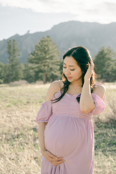 Colorado expecting mom wearing a purple dress during her maternity session