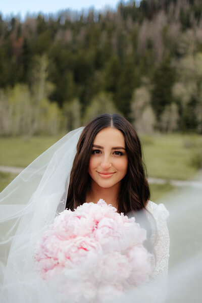 Utah mountain bridal shoot with wedding dress, veil, and blush bridal bouquet.