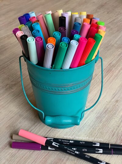 Colorful buckets of markers