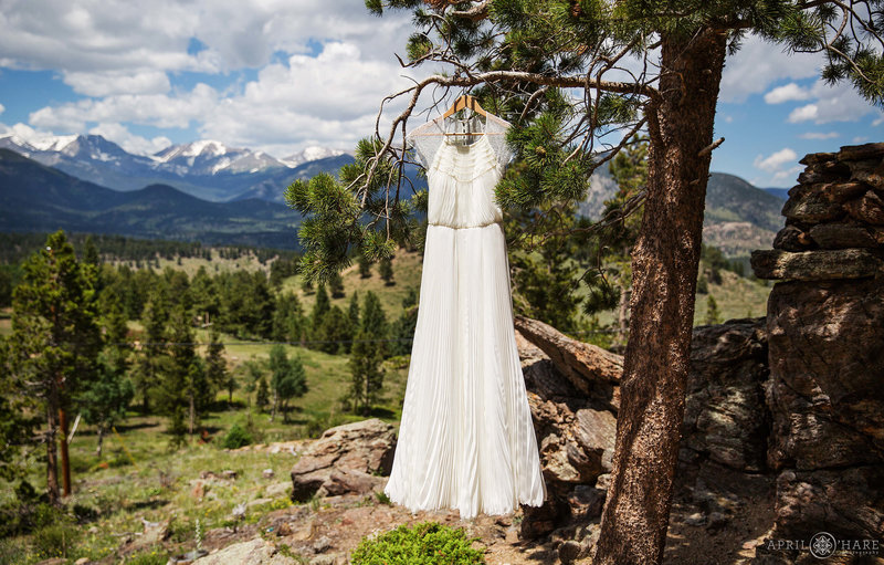 A pretty dress hangs at YMCA of the Rockies with a stunning mountain view in the backdrop in Estes Park Colorado