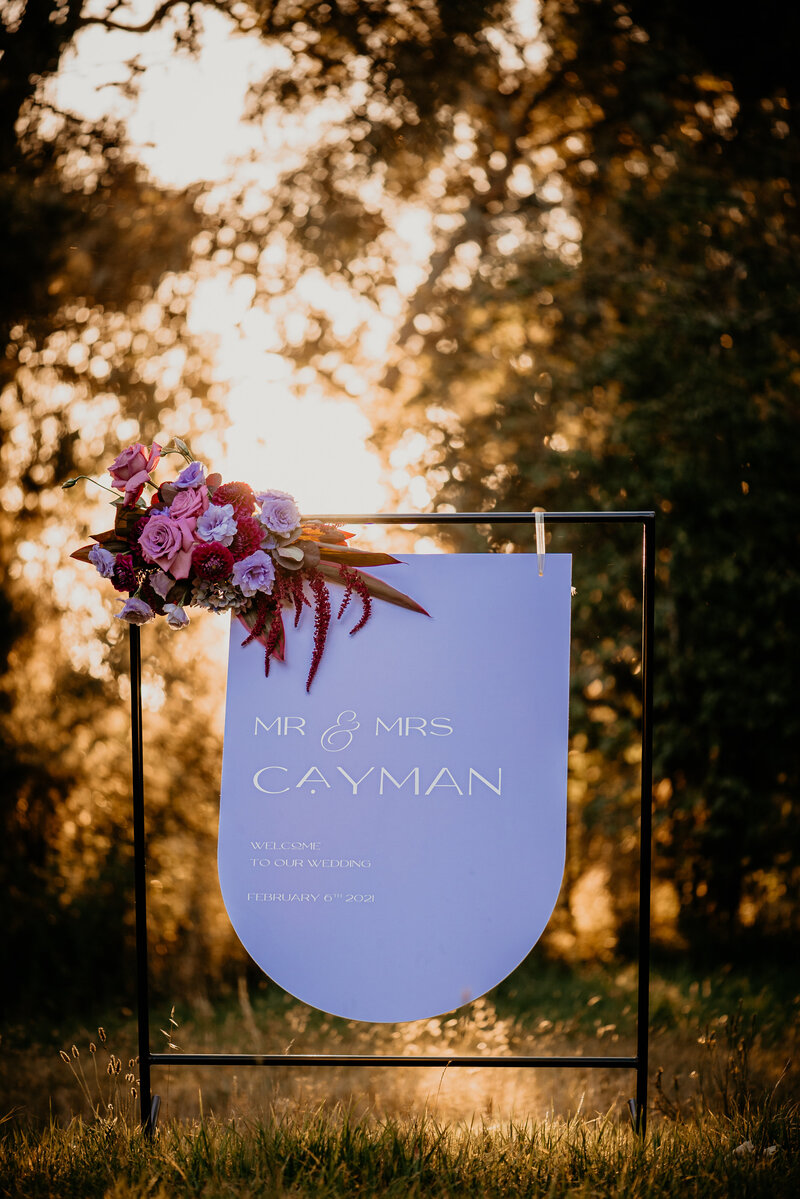 Purple arched wedding welcome sign