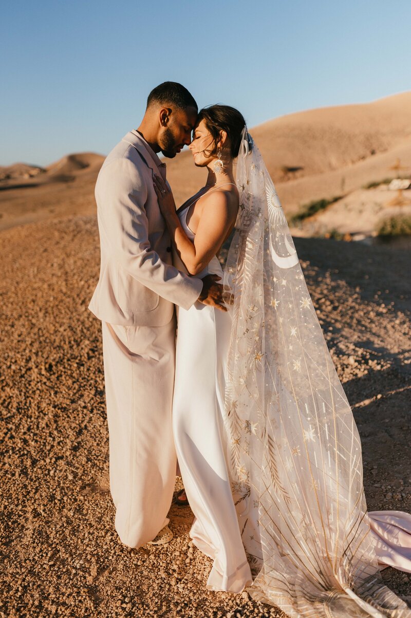 Megan and James at sunrise before their wedding in the Agafay Desert in Marrakech.