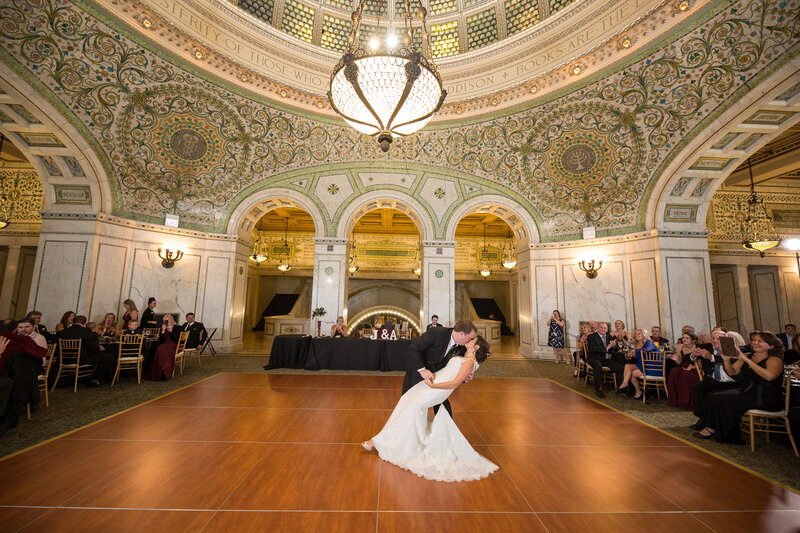 Bride and groom kiss at their wedding reception in Preston Bradley Hall at the Chicago Cultural Center.