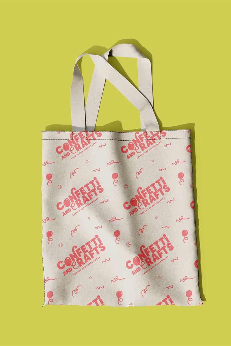 A mockup of a tote bag branded with the Confetti and Crafts logo