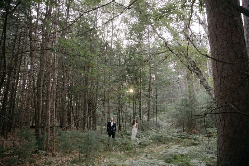 Groom and bride standing in woods of Colorado during intimate backyard wedding