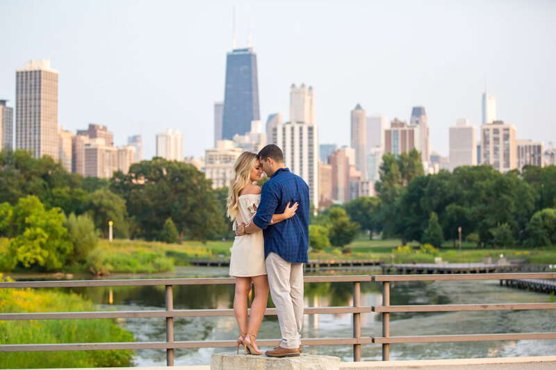 Modern engagement pose at a bridge overlooking downtown Chicago.