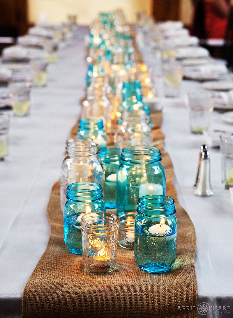 Blue-and-White-Mason-Jars-with-Floating-Candles-on-Burlap-from-a-Cowbou-Gourmet-Catering-and-Events-in-Vail-Colorado