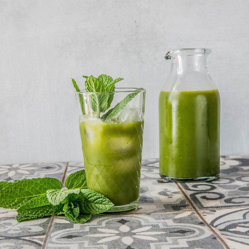 green drink photography with arugula spinach apple and mint juice