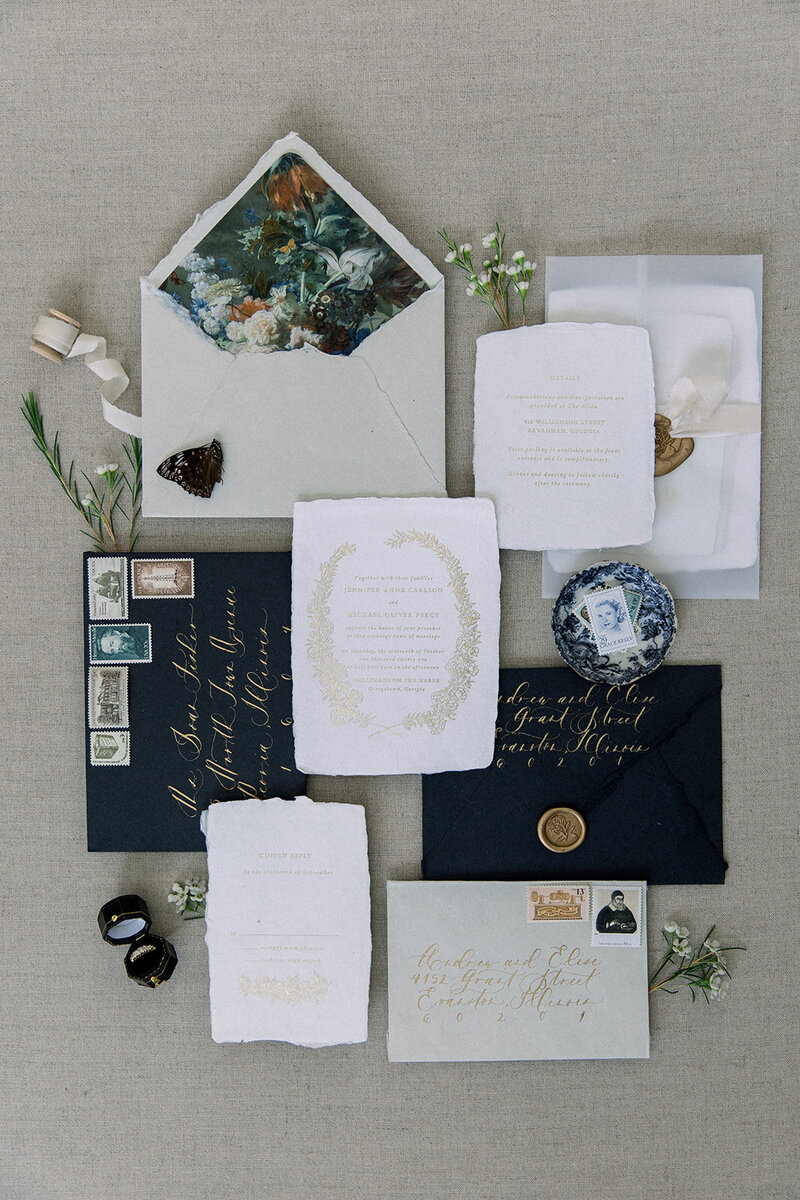 wedding stationery flat lay with butterflies and antique items