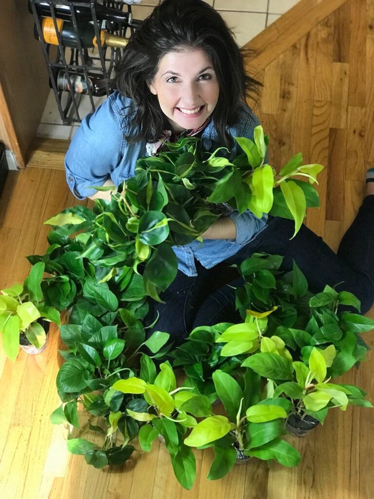 Woman wrapped in garland of plants
