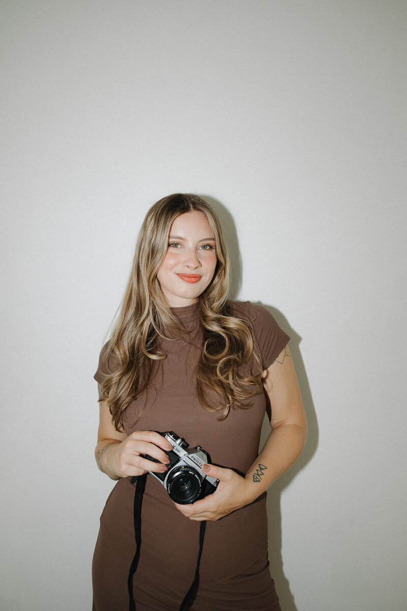 photographer holding film camera