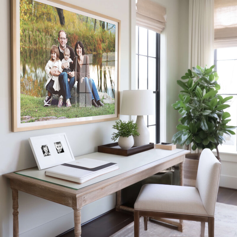 Framed family photo by Raleigh NC Family photographer hung over a desk in a stylish home.