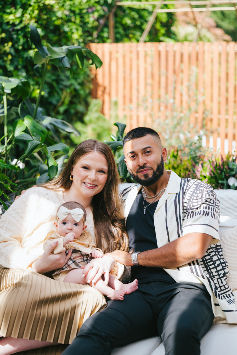 Virtual assistant agency owner Kate sitting outside with husband and baby
