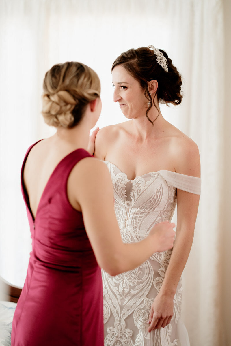 Bride and Maid of honor getting ready for the ceremony