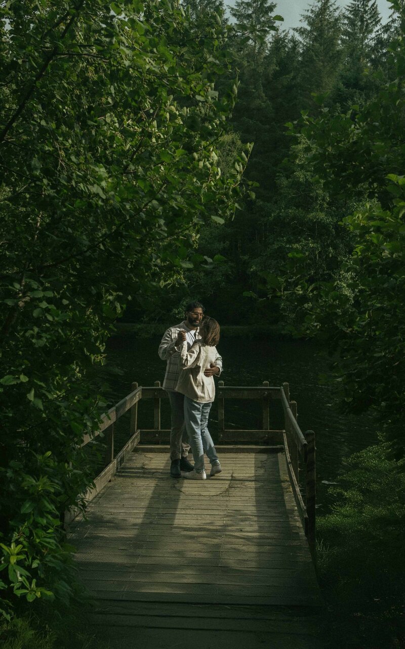 Romantic secret proposal at Glencoe Lochan, capturing a couple's intimate moment while slow dancing in a breathtaking Scottish landscape