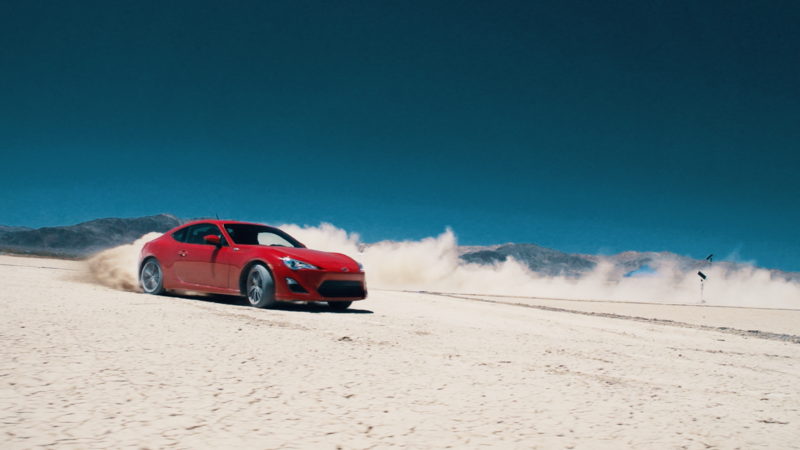 Red car speeding in the desert-FillmCo