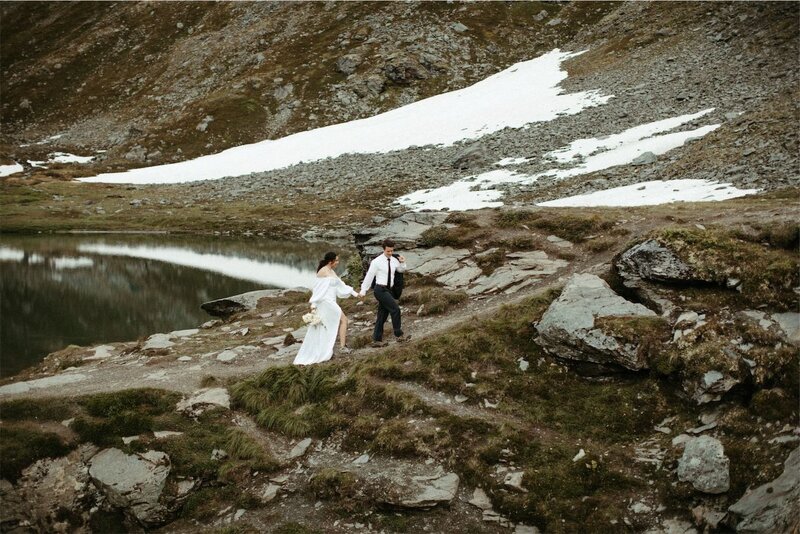 Couple walking  up a mountainside in hatchers pass