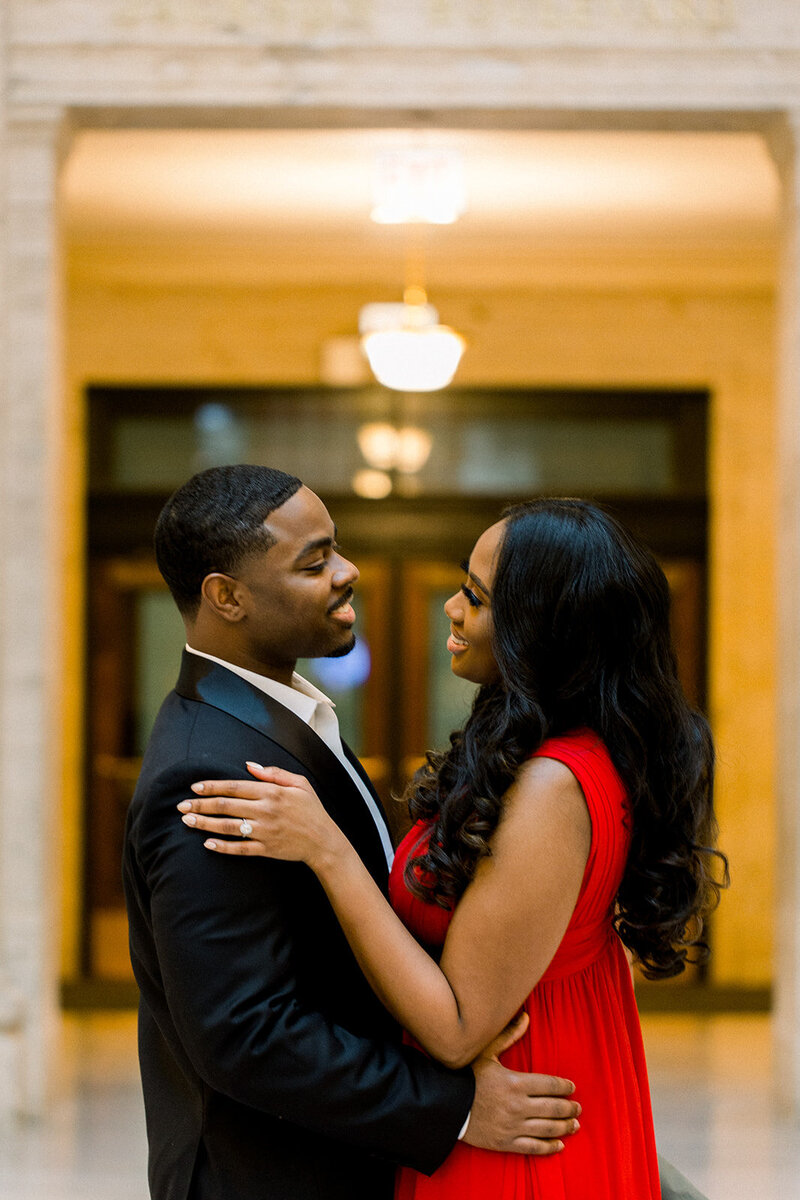 engaged couple embracing at union station chicago