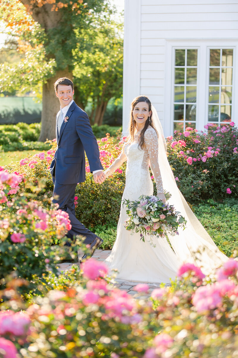 wedding couple walking through garden
