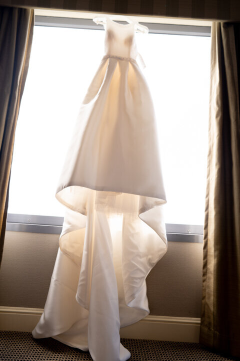 Wedding dress hanging in the window