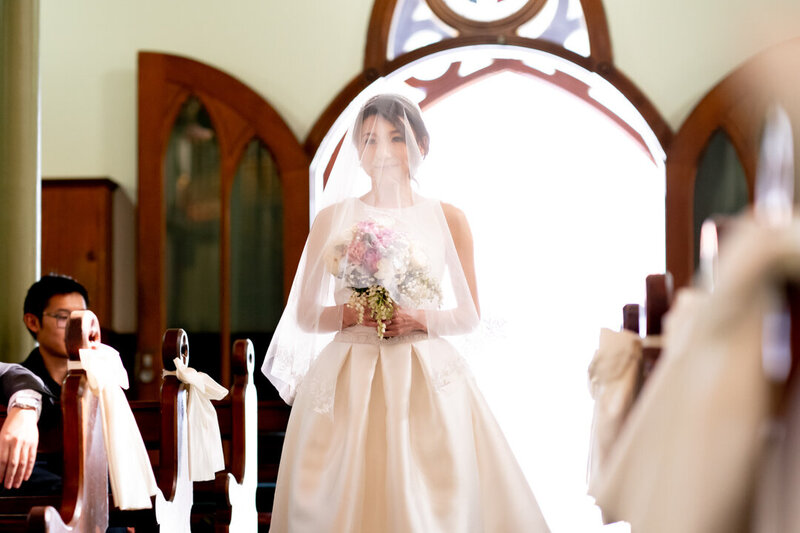 Bride walks down the aisle at church