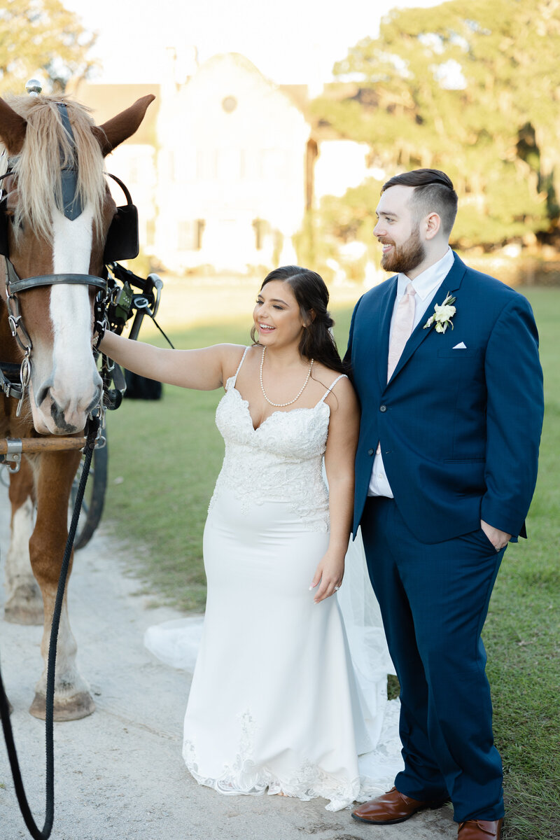 bride and groom petting horse