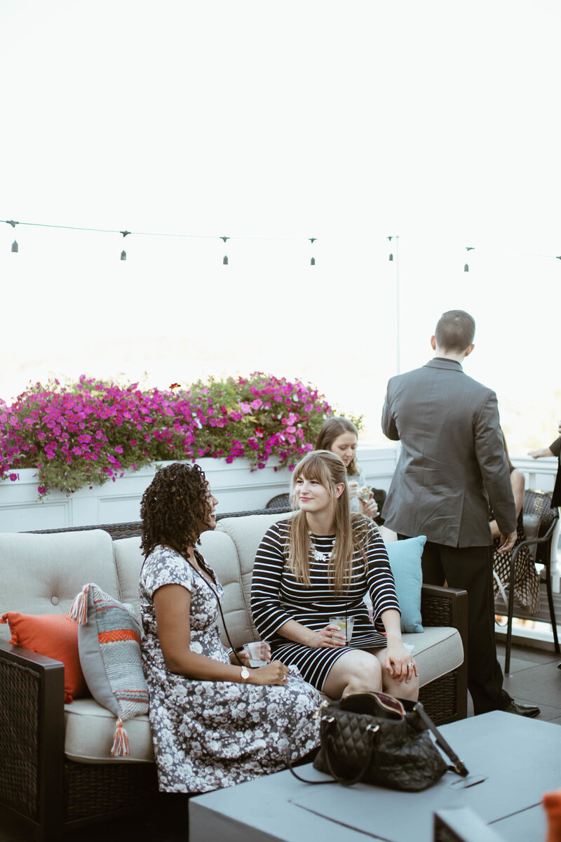 wedding guests have conversation on patio