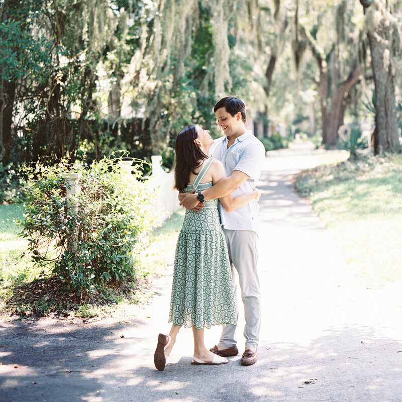 Couple posing for engagement photos in Charleston South Carolina