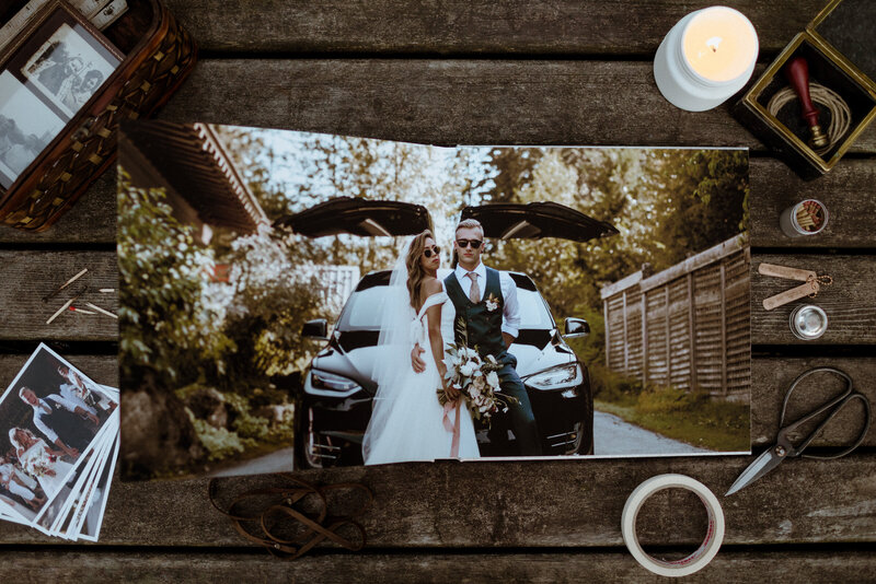 Flatlay of an opened wedding album showing a bride and groom portrait