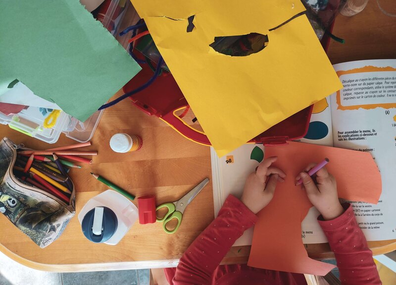 A student working on arts and crafts at their table