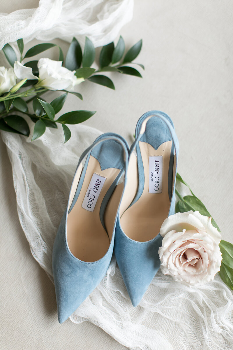 Blue Jimmy Choo shoes with wedding bouquet.