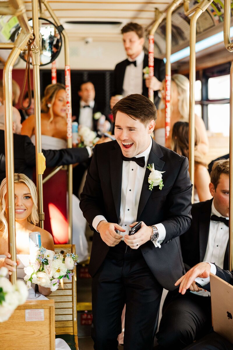 groom on knoxville trolley by knoxville wedding photographer