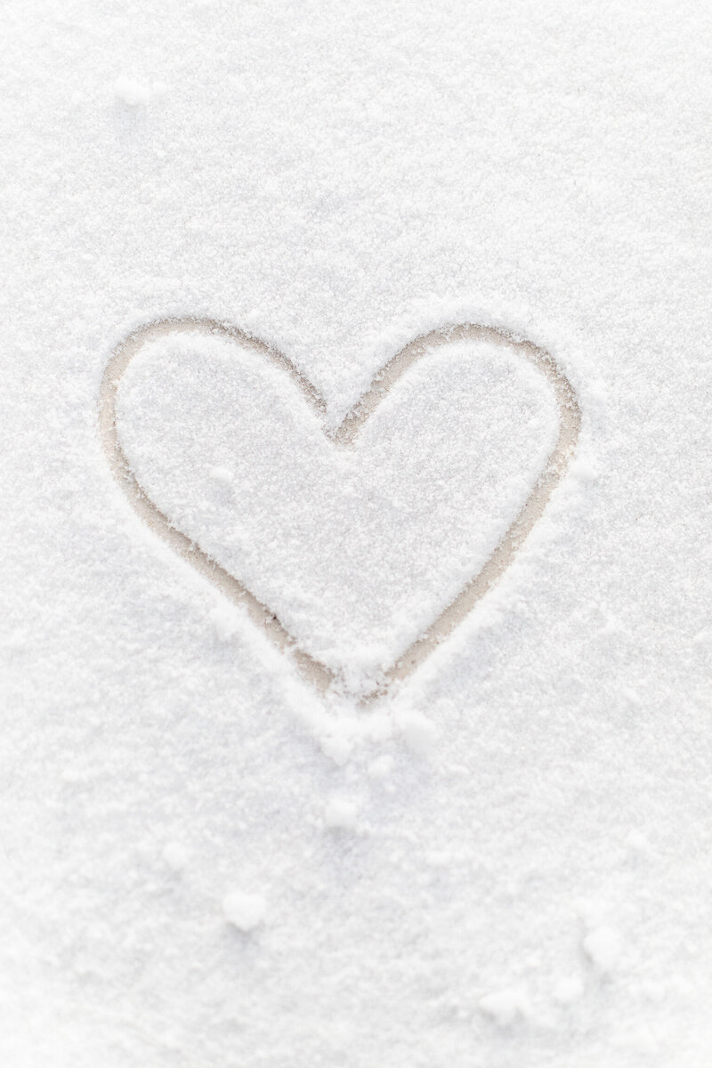 Heart drawn in snow to reflect the warmth and wonder of Santa, with pictures with Santa Tulsa 