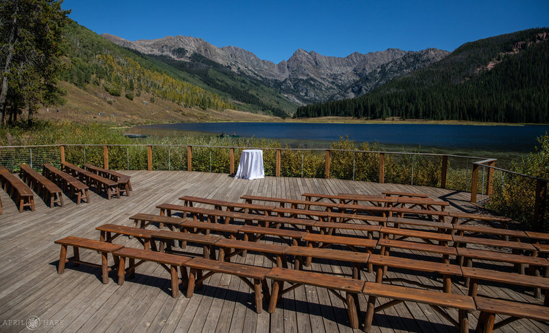 View of the ceremony space on the outdoor deck with wood benches at Piney River Ranch