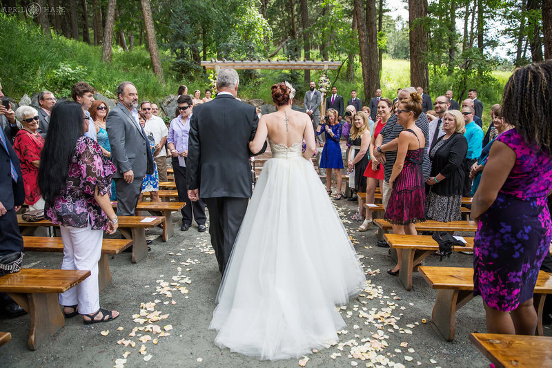 Father and bride walk down the aisle on the Evergreen Terrace at The Pines at Genesee in Colorado